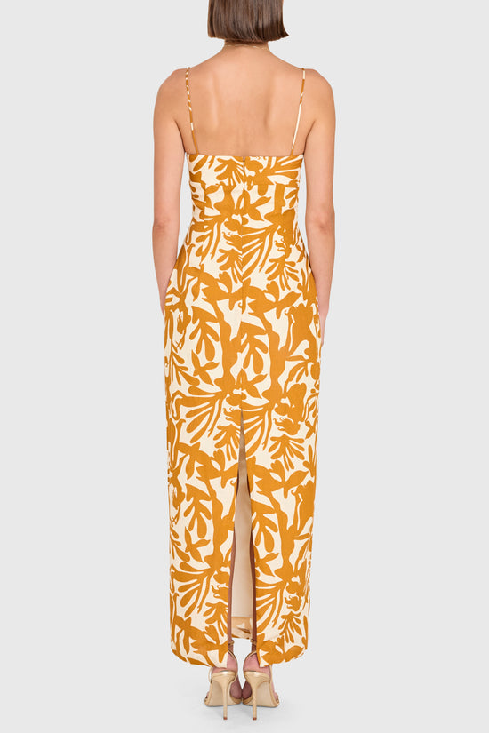 Woman wearing a yellow floral dress on a white background