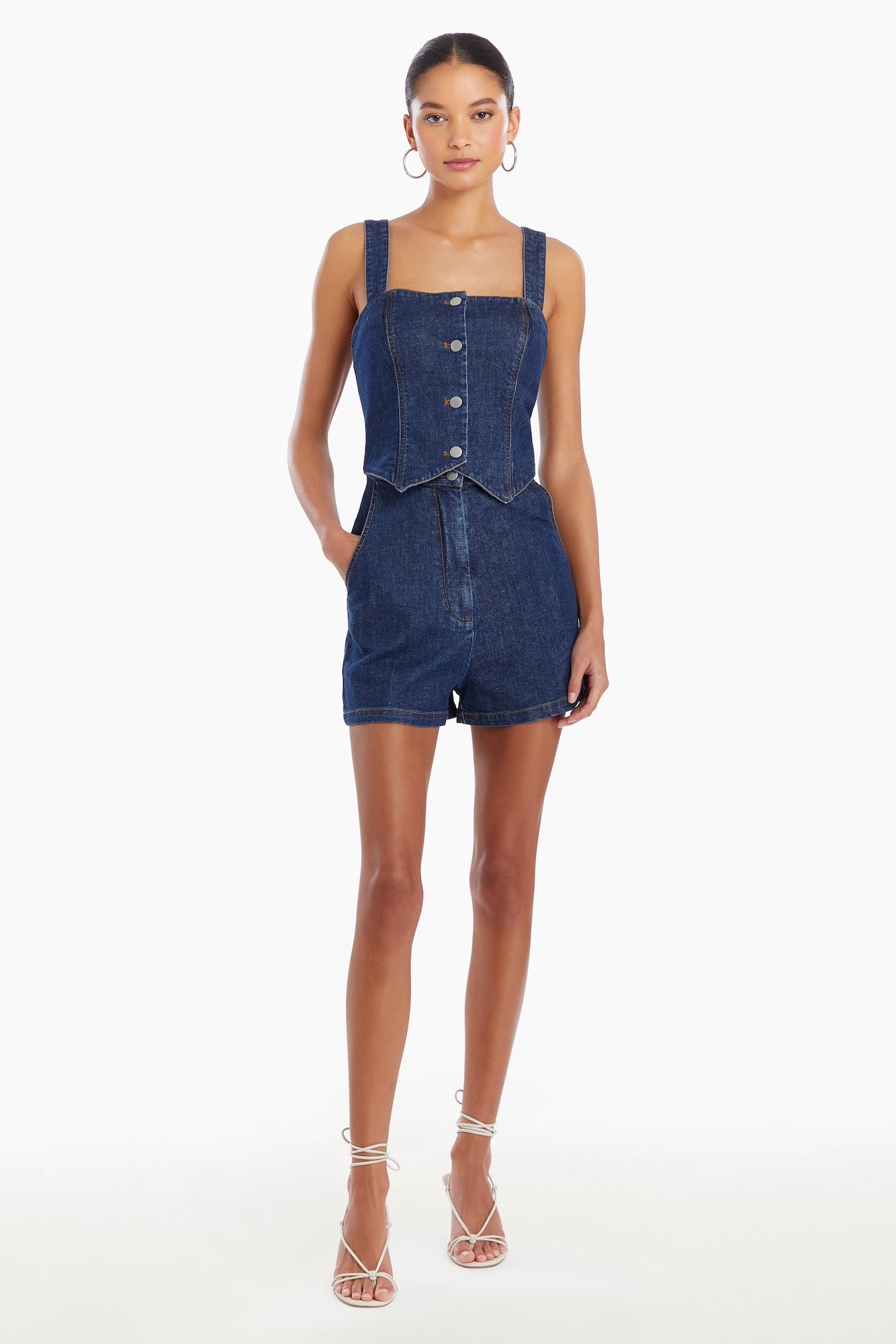 Girl in denim romper, front facing.