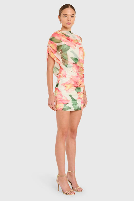 Amanda Uprichard |   Marcelle Dress in Hibiscus Print. Model wears a floral mini dress against a white backgorund. view 3