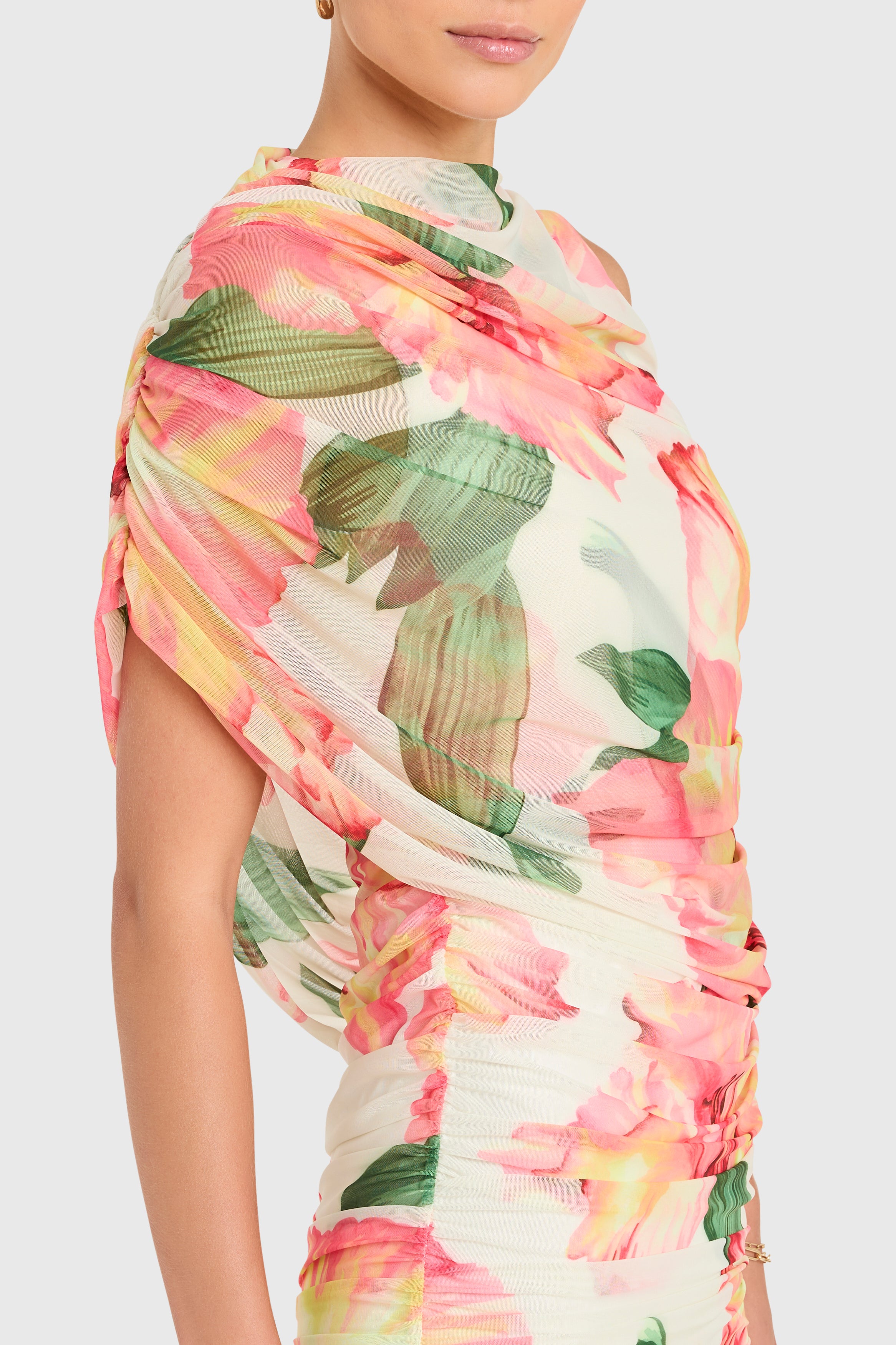 Amanda Uprichard |   Marcelle Dress in Hibiscus Print. Model wears a floral mini dress against a white backgorund.