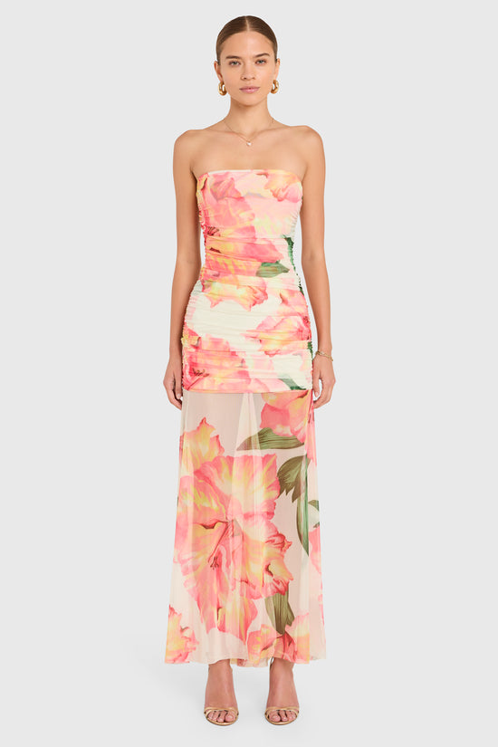 Amanda Uprichard |   Leo Maxi Dress in Hibiscus Print. Model wears a full length strapless floral dress against a white backgorund. view 1