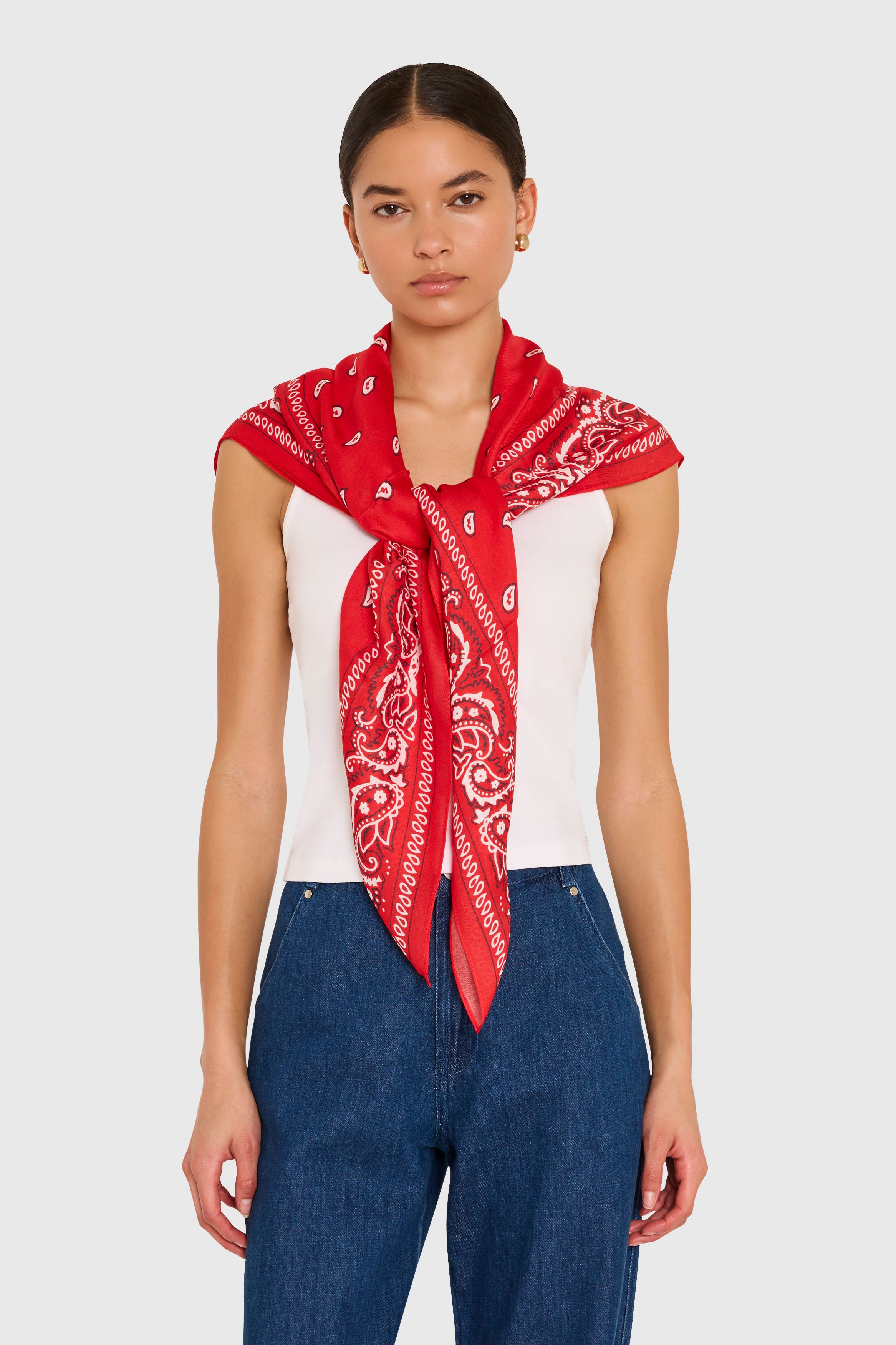 Amanda Uprichard XL Bandana Scarf in Red. Model wears scarf around her shoulders against a white background. 
