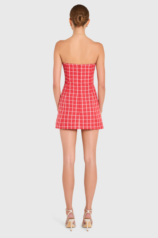 Amanda Uprichard |   Daisy Romper in Mackenzie Plaid. Model wears a red and white plaid strapless mini dress against a white backgorund. view 3