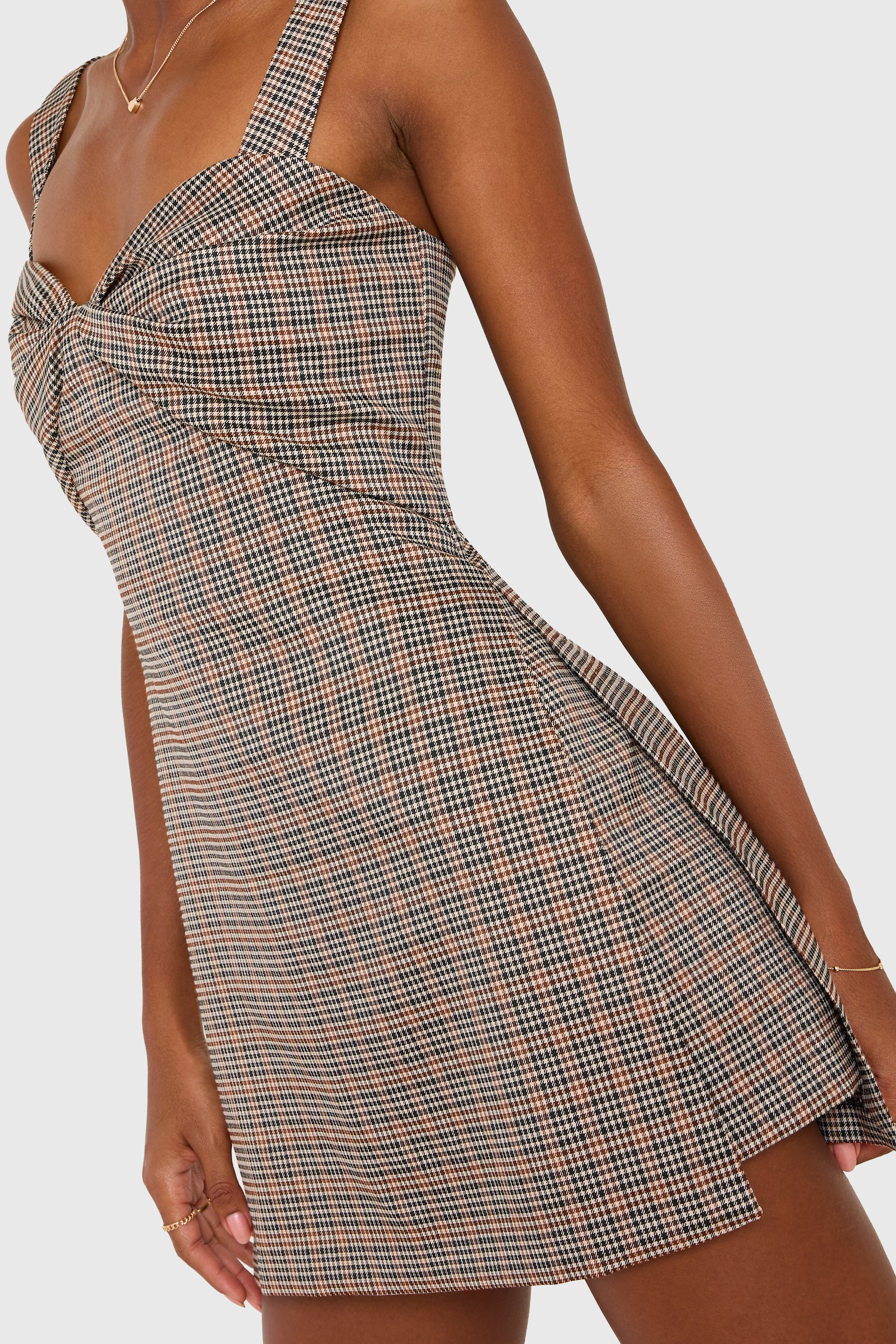 Plaid dress worn by a model on a white background