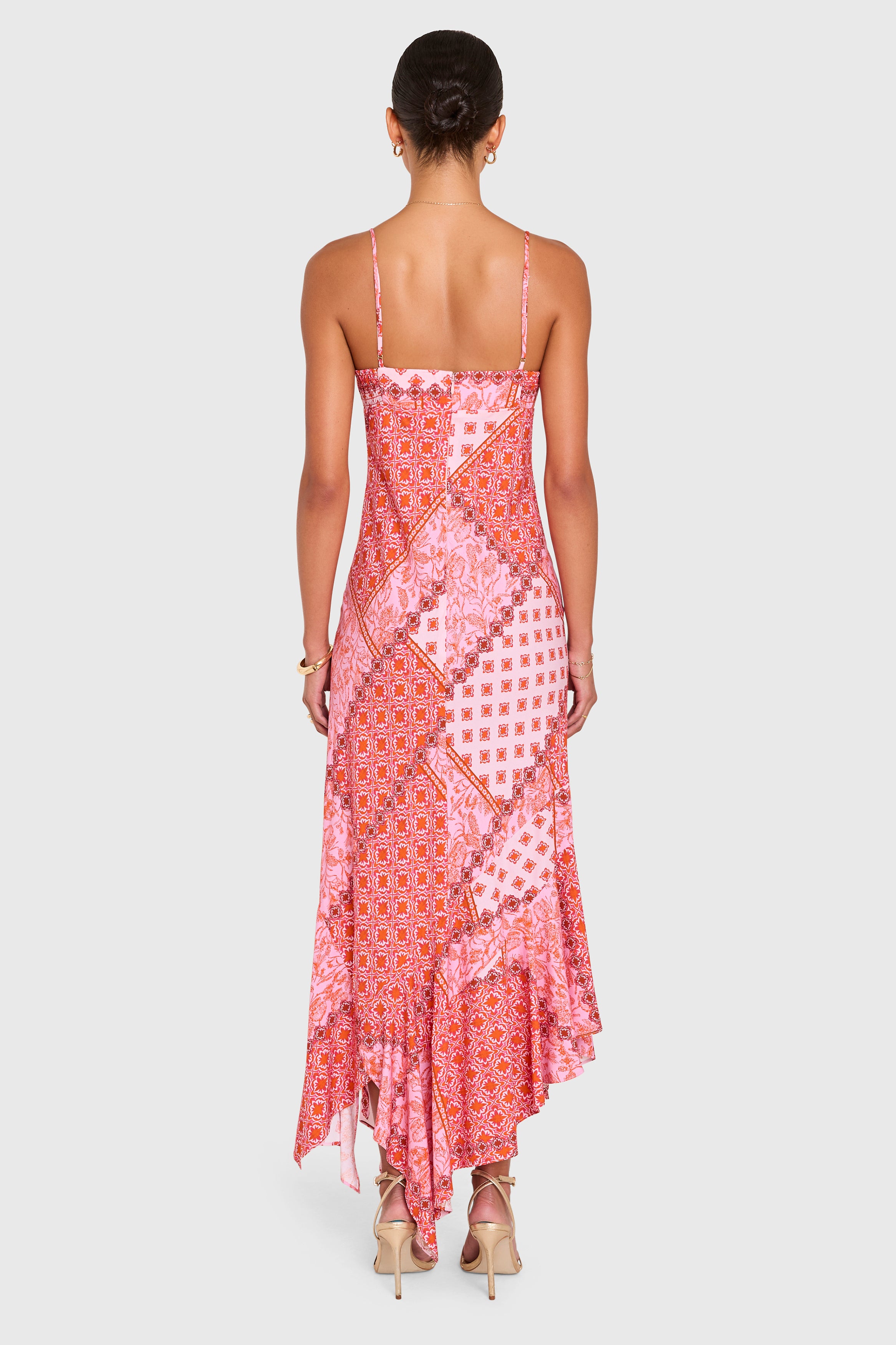 Amanda Uprichard |   Kaysee Maxi Dress in Sardinia Print. Model wears a pink patchwork patterened dress against a white backgorund.