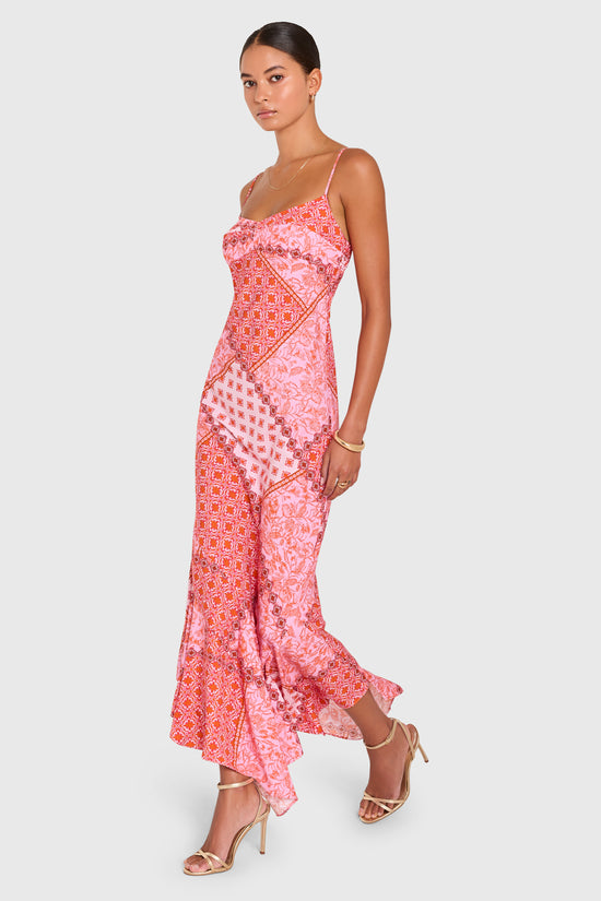 Amanda Uprichard |   Kaysee Maxi Dress in Sardinia Print. Model wears a pink patchwork patterened dress against a white backgorund. view 3