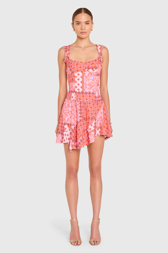 Amanda Uprichard |   Mila Skort in Sardinia Print. Model wears a pink patchwork patterened mini skirt against a white backgorund. view 3