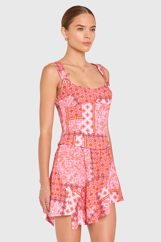 Amanda Uprichard |   Candice Top in Sardinia Print. Model wears a pink patchwork patterened top against a white backgorund. view 3