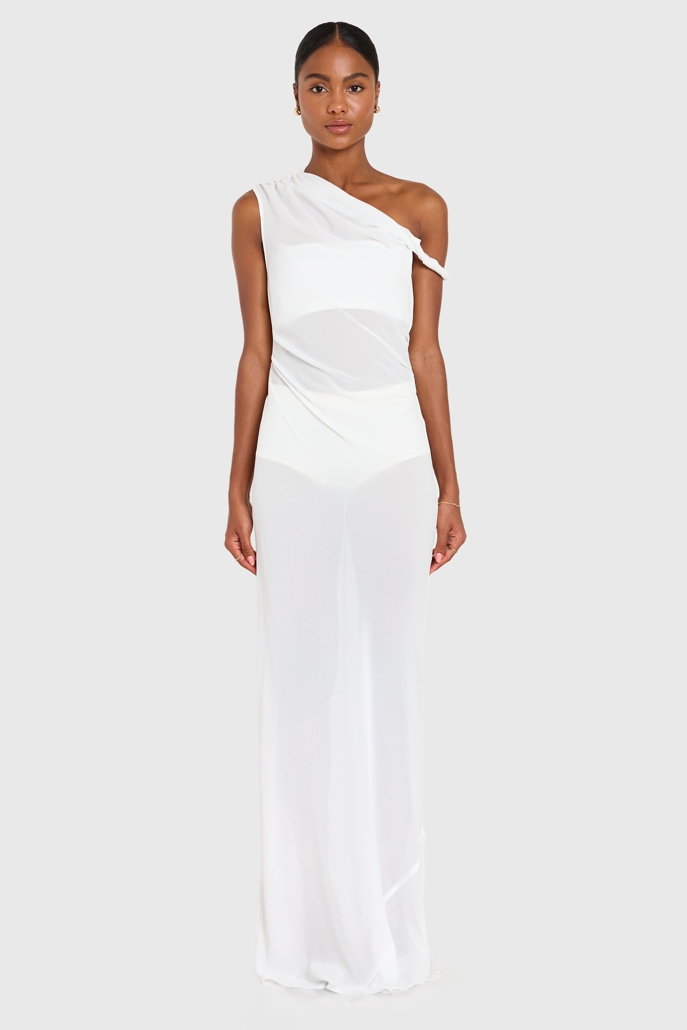 Woman wearing a white one-shoulder dress on a white background
