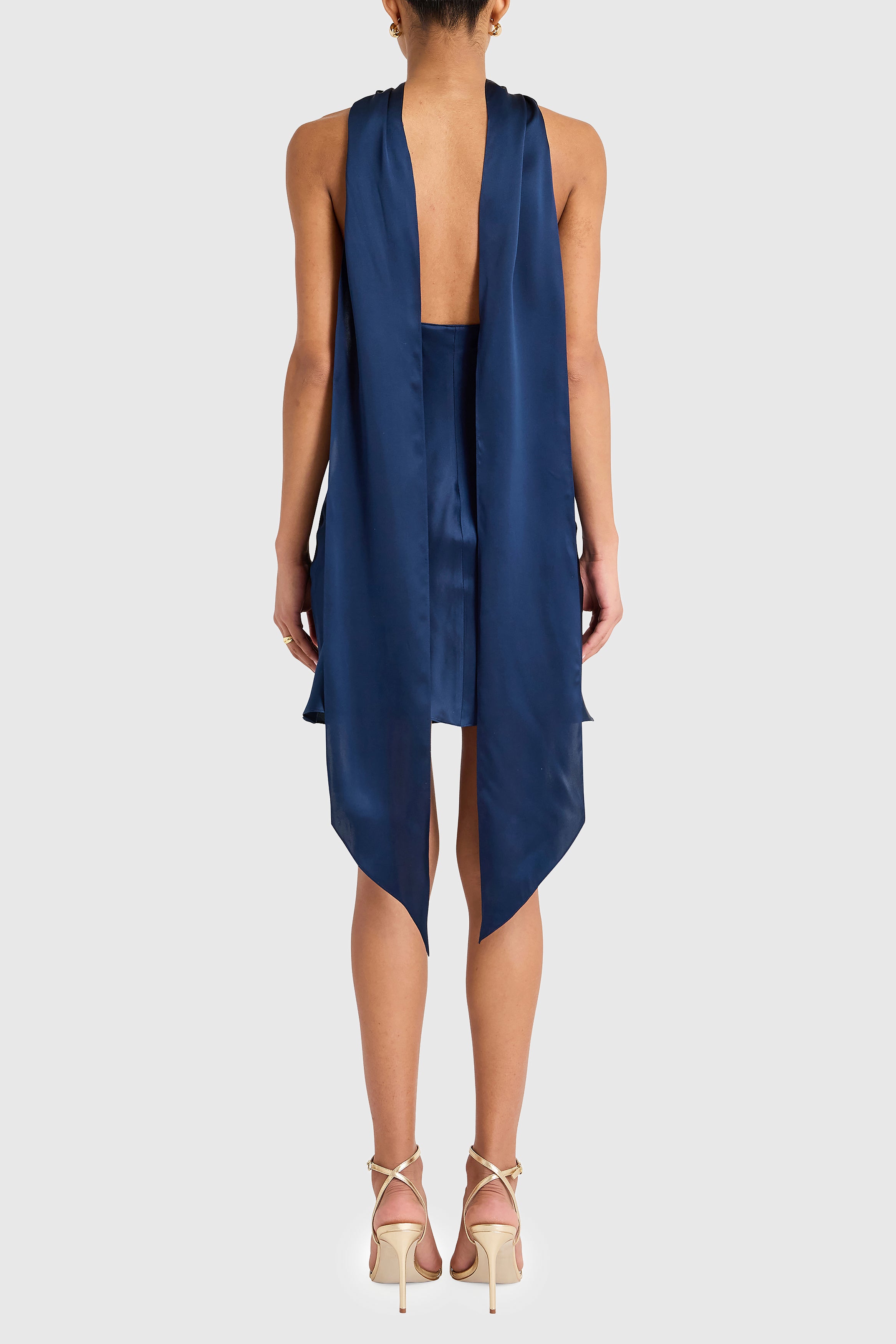 Navy blue dress with open back on a white background