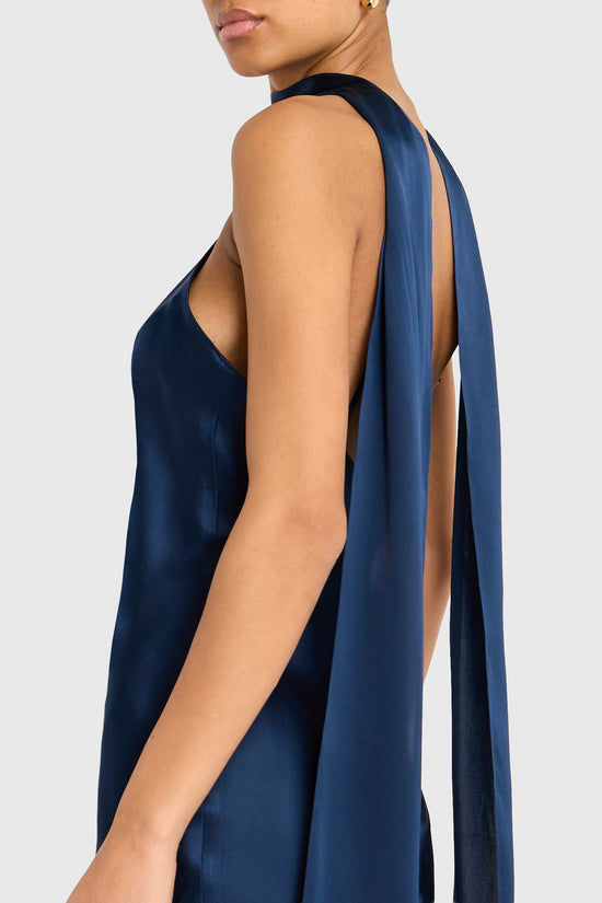 Navy blue satin dress with a draped back on a white background