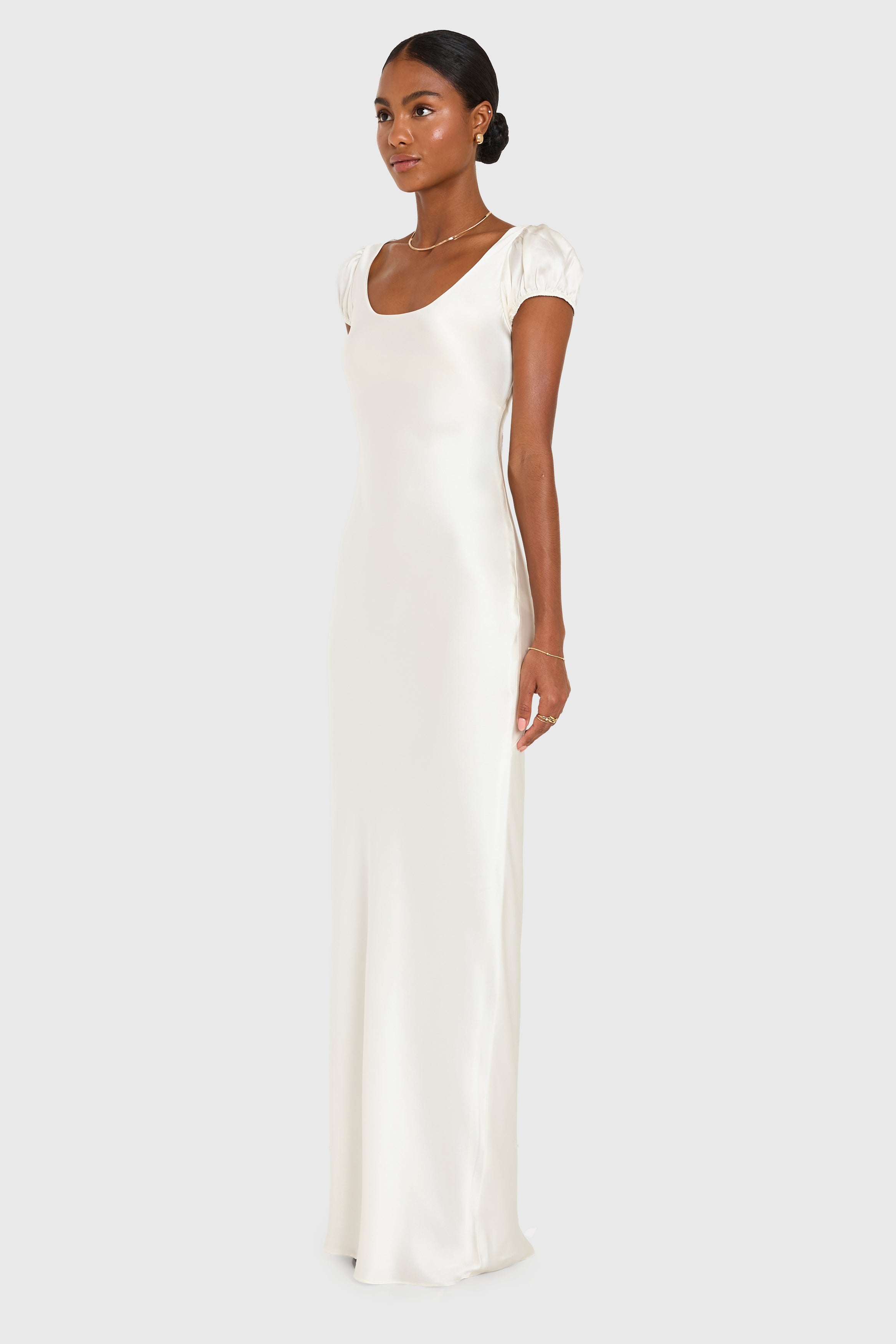 Woman wearing a white evening gown on a white background
