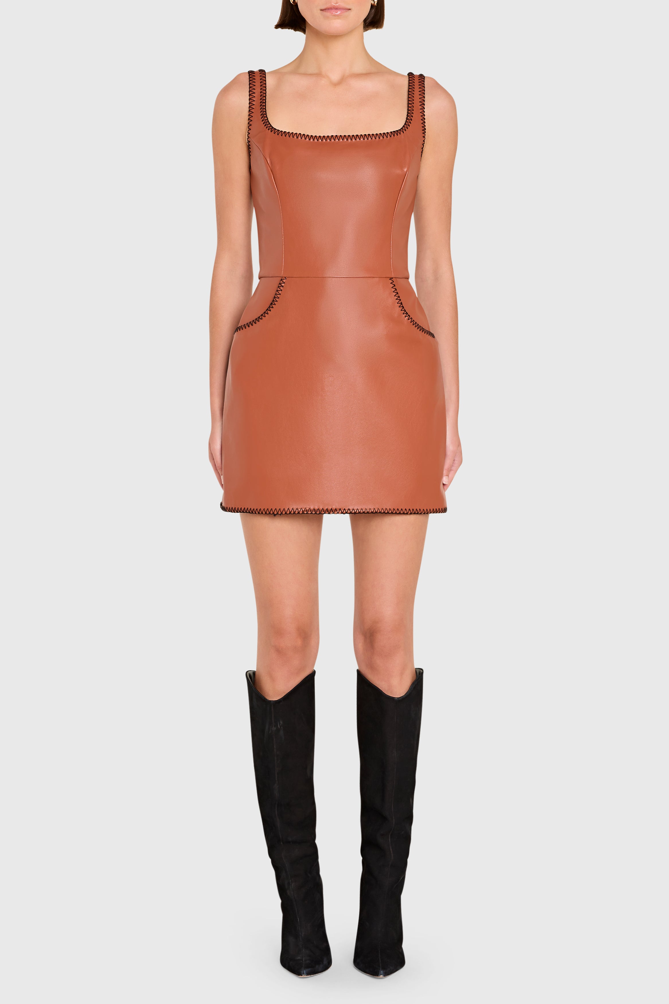 Brown leather dress worn by a model on a white background