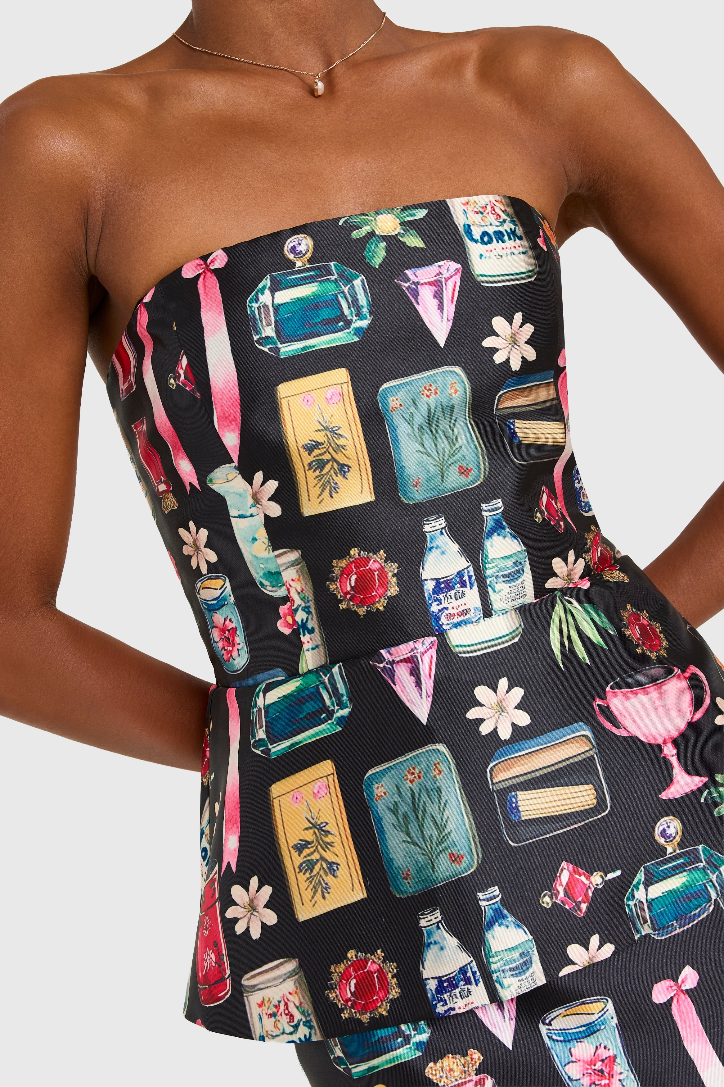 Black strapless dress with colorful graphic design on a model against a white background