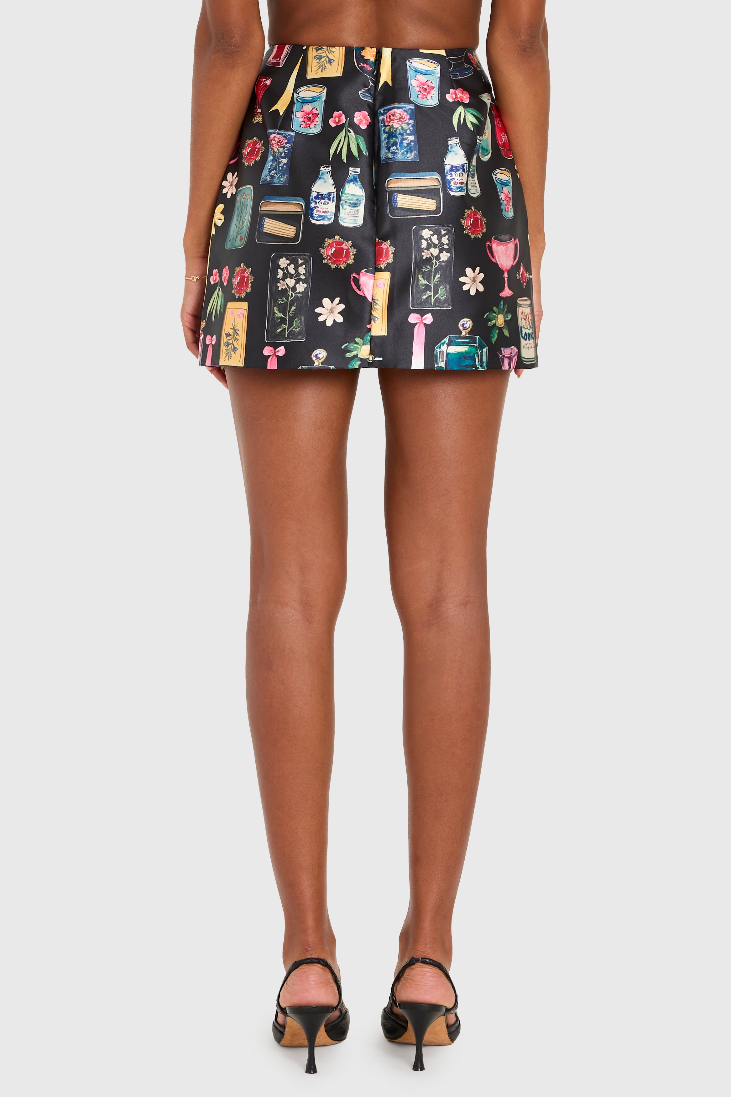 Skirt with colorful pattern worn by a person on a white background