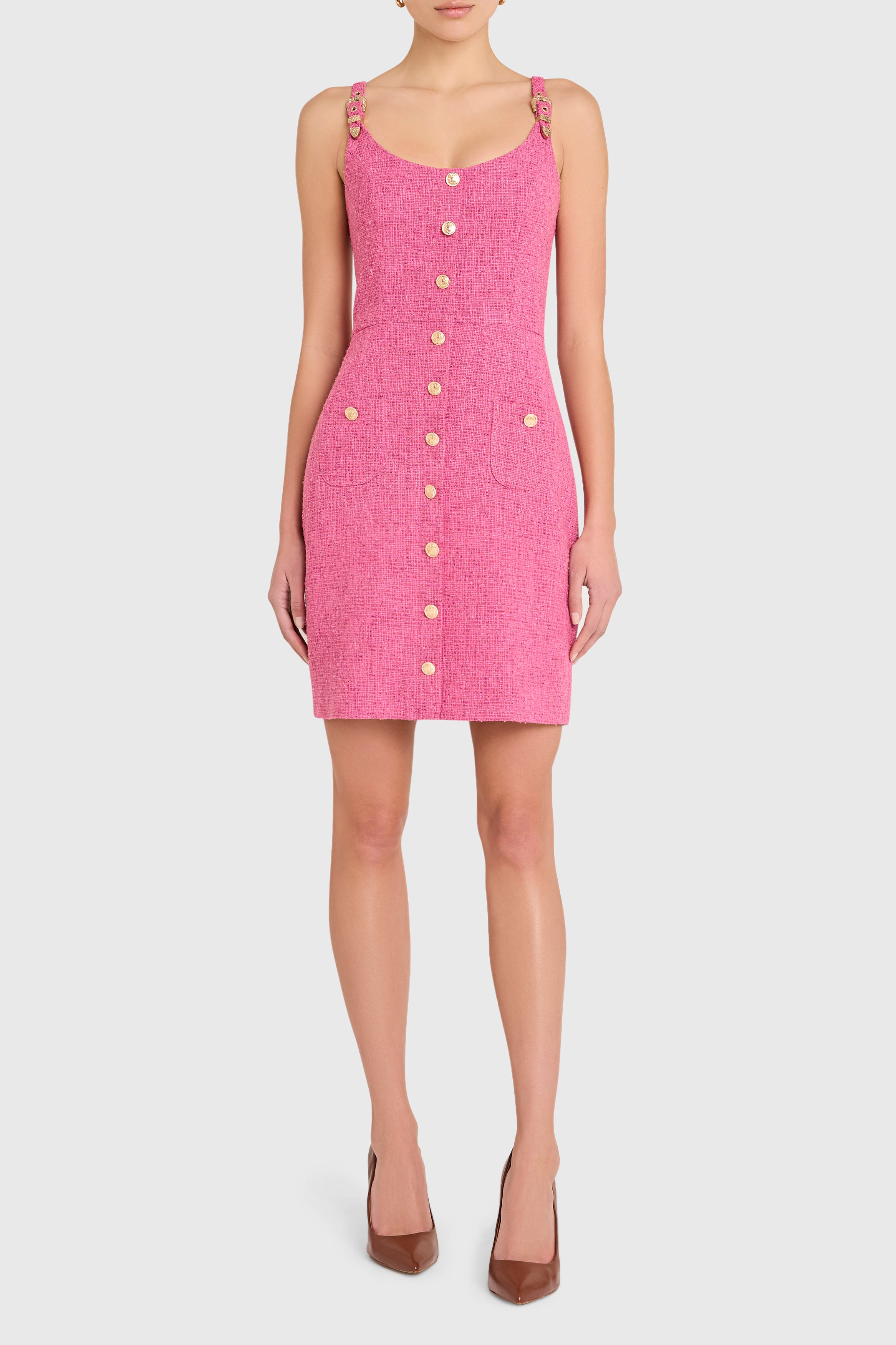 Pink dress with button details on a white background
