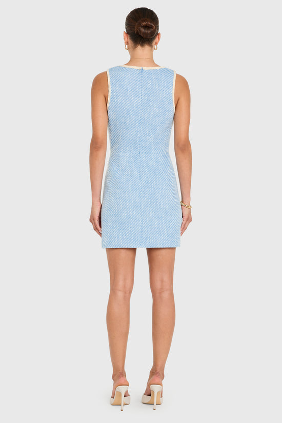 Woman wearing a light blue patterned dress on a white background view 3