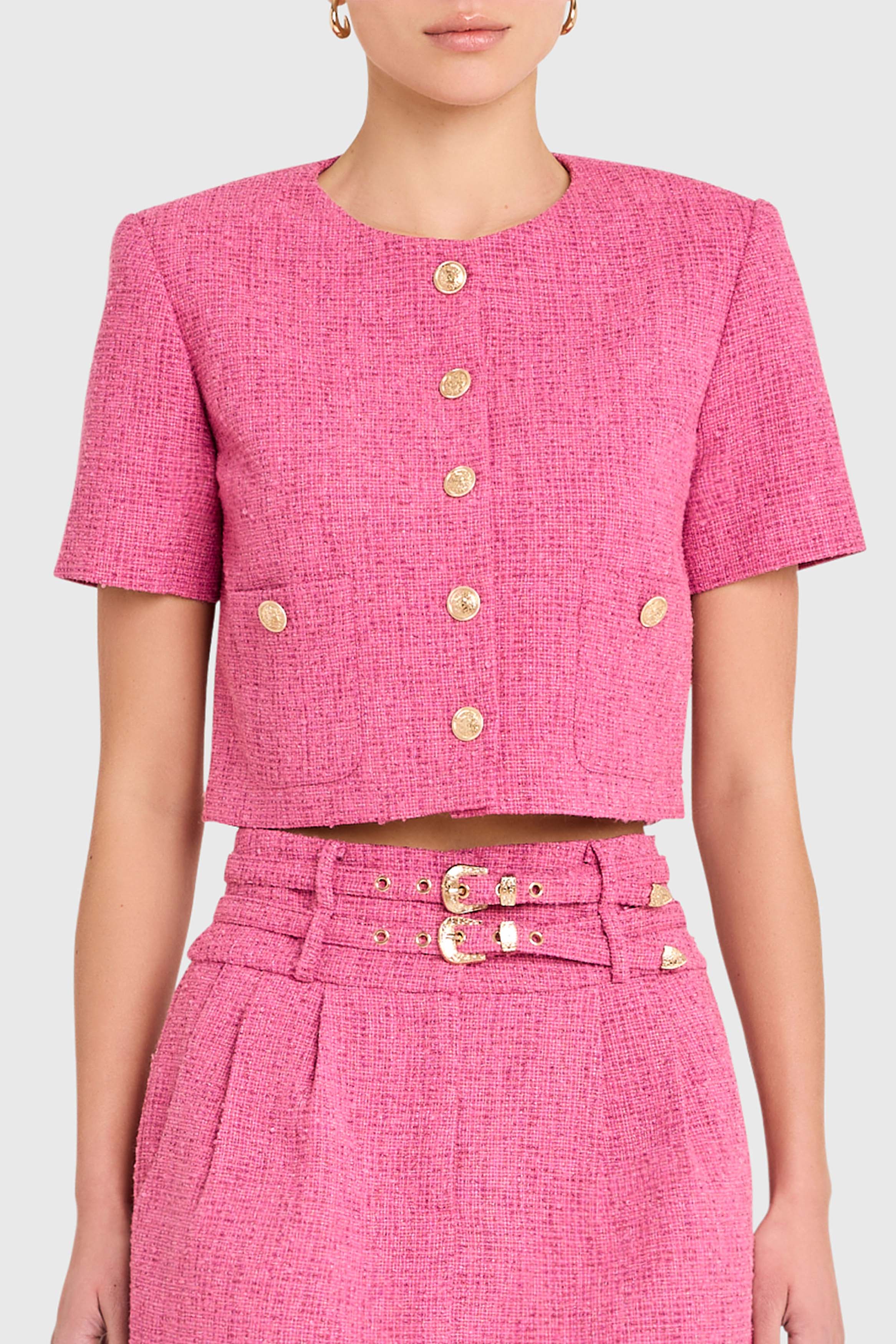 Pink textured outfit with a belt on a white background