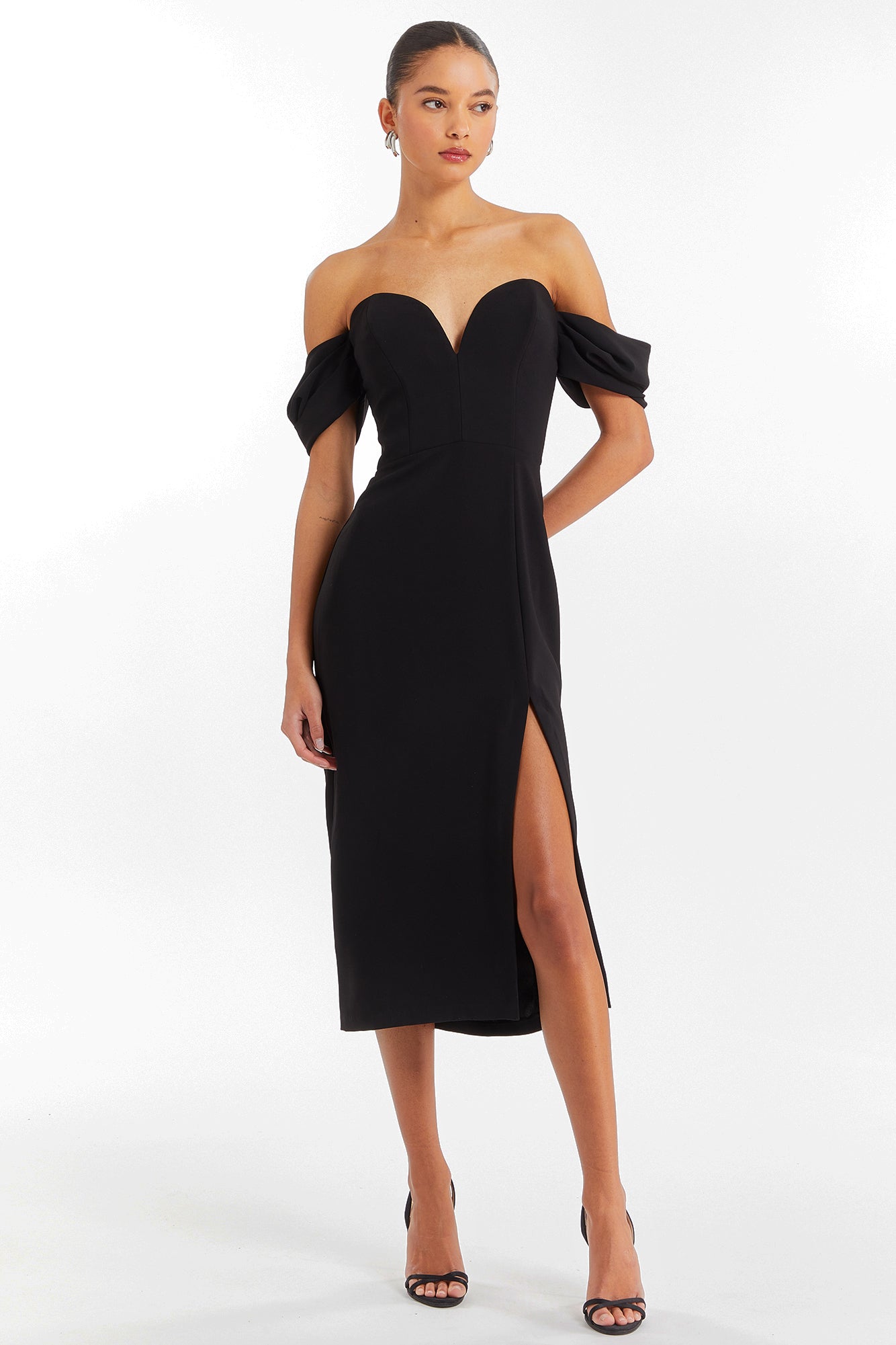 Girl in black off the shoulder midi dress, front facing.