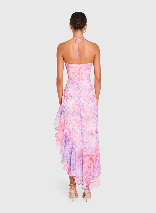 Woman wearing a strapless floral dress on a white background