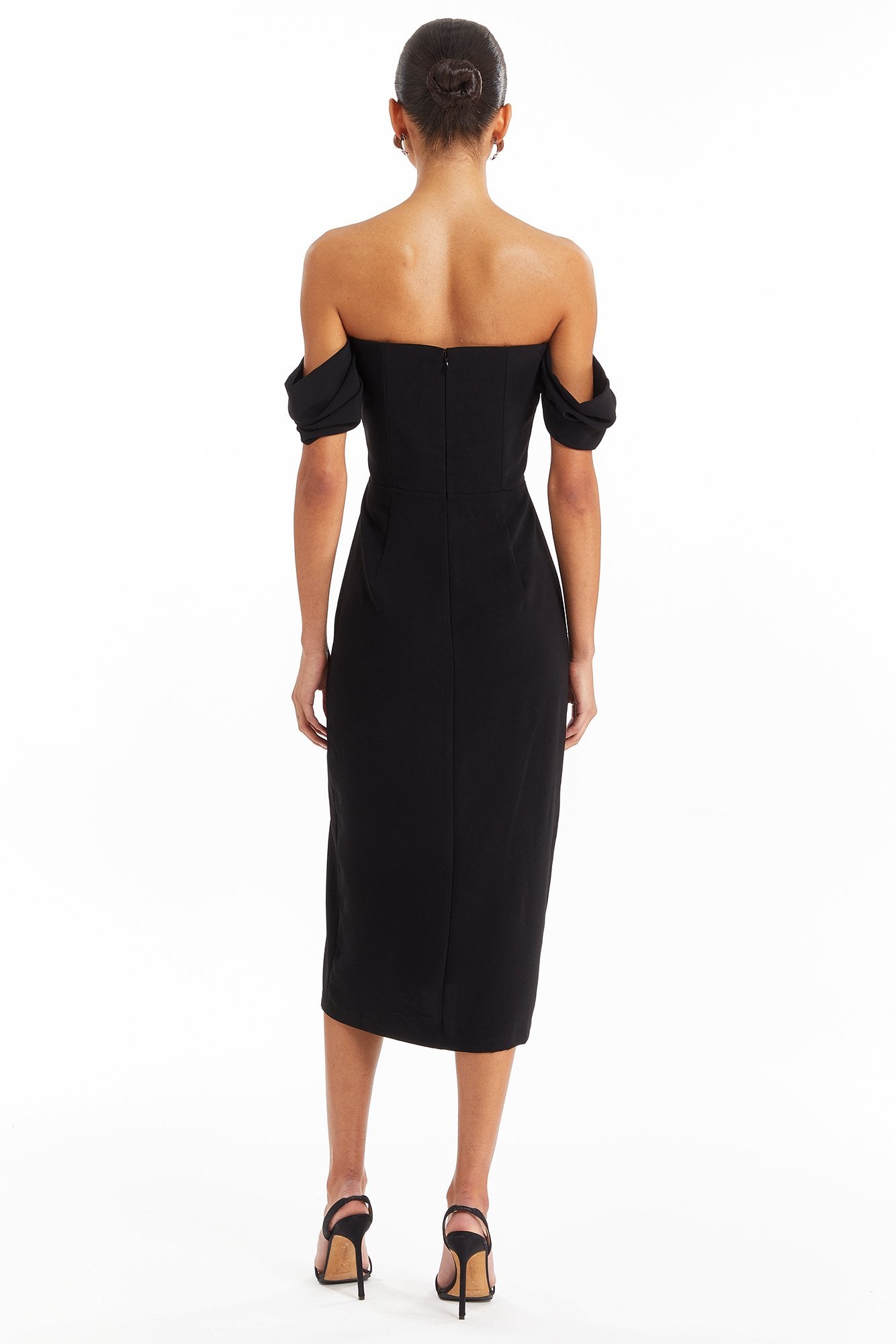 Girl in black off the shoulder midi dress, back facing.