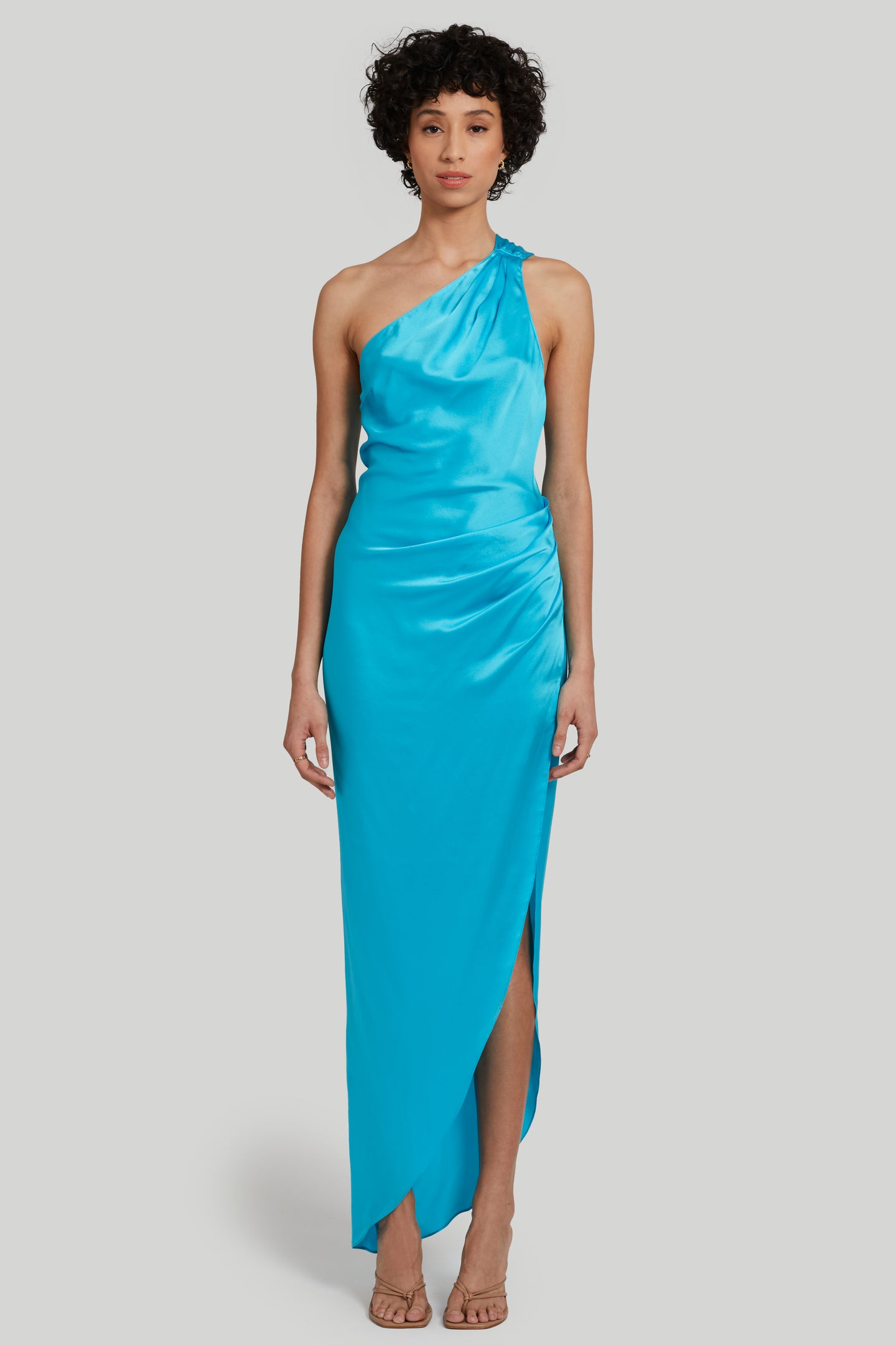 blue silk one shoulder asymmetrical gown with high slit